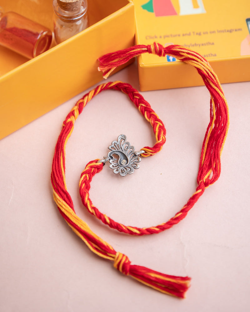 925 pure silver handcrafted dancing peacock rakhi, close-up