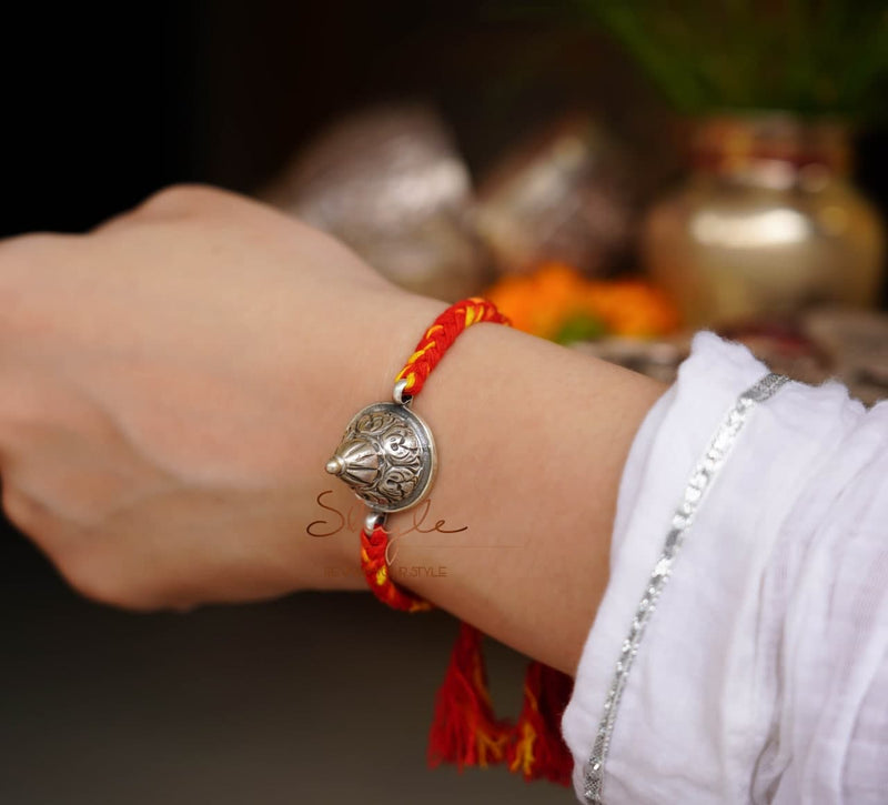 925 pure silver chitai embossed dhaal rakhi, close-up